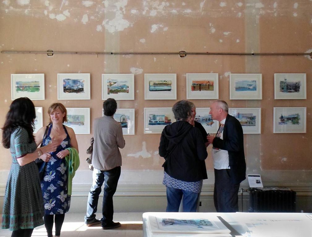 Sarah Jones' display of prints being looked at by visitors 