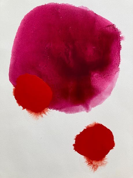 Art image comprising one large, vivid, red ink spot and a similar, smaller one