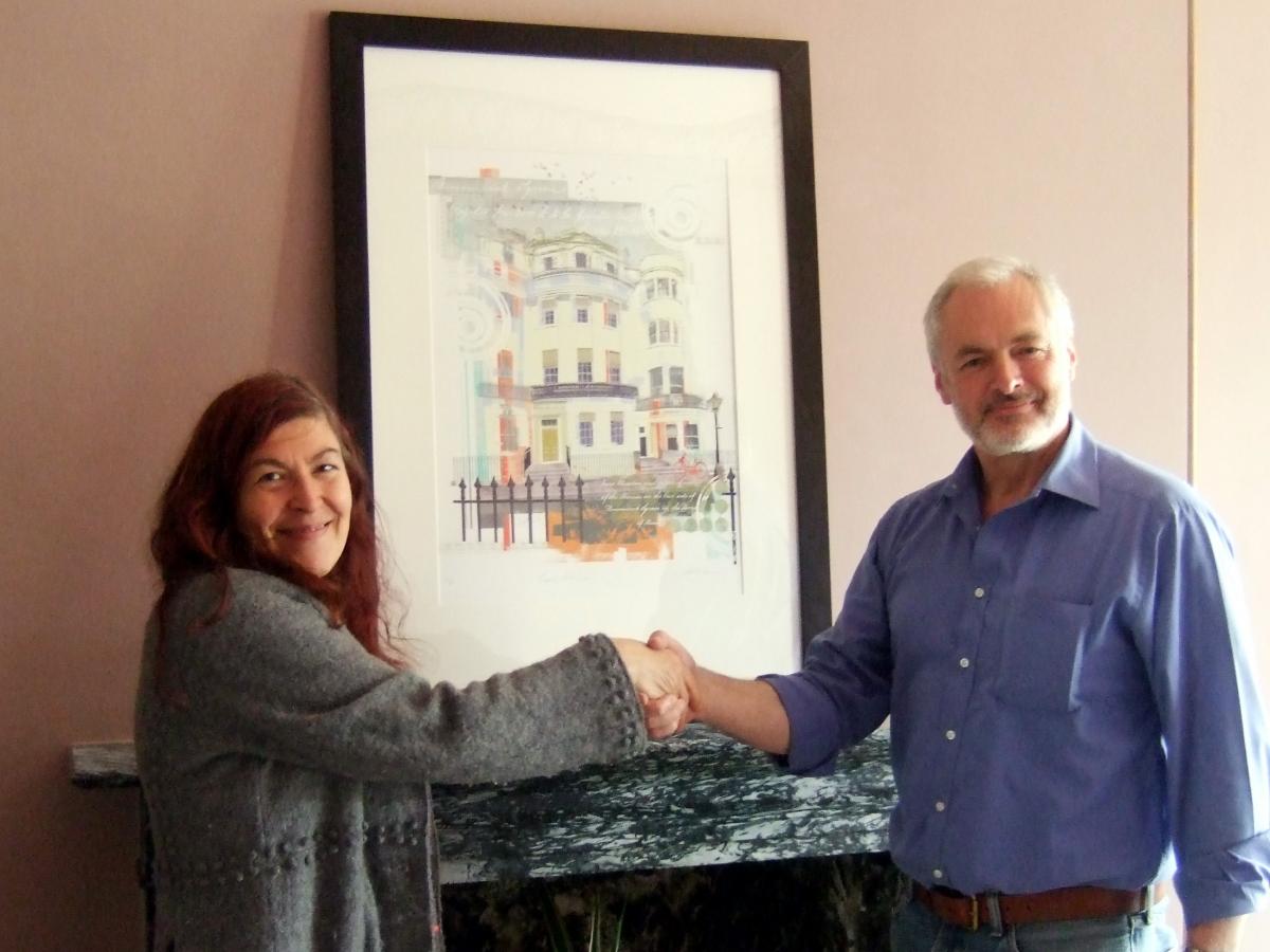Raffle winner Gill Rosenberg collecting the Sarah Jones's Regency Town House print pictured with Nick Tyson