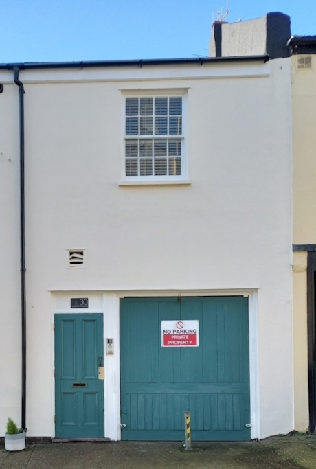 A colour photo of a residential buidling previously used as stables