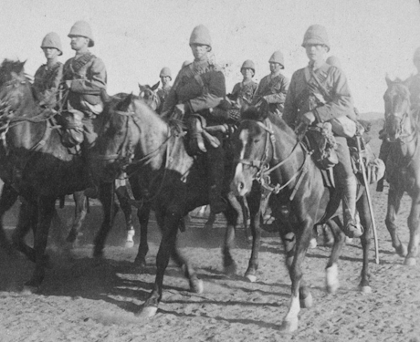 Monochrome photo of soldiers riding horses