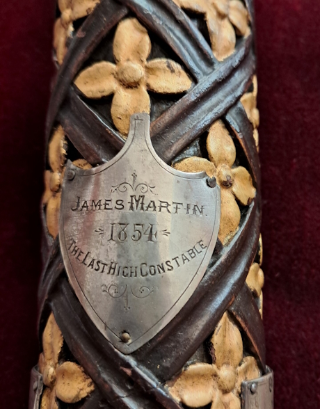 A colour photo showing a close-up of an ornate staff