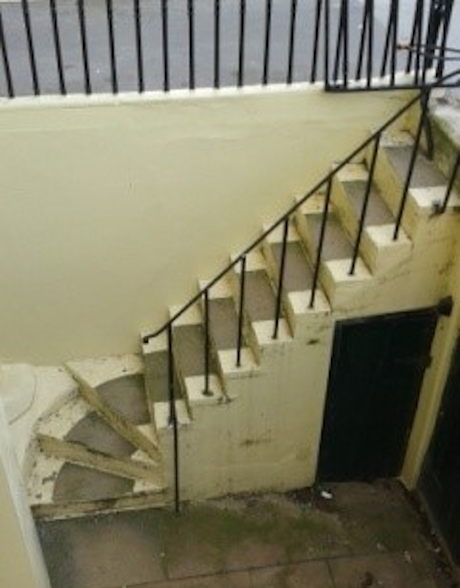 colour photo of stone steps leading to a basement