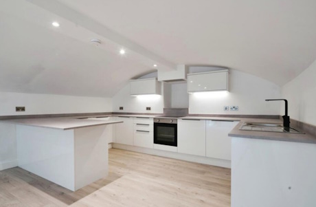 Colour image of a white painted new kitchen