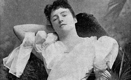 Photo taken c.1895. It shows opers singer Margaret Macintyre in a white dress and reclining on a chaise