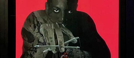 Graphical artwork, depicting a shadowy figure on a red background manipulating the strings of a puppet