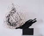 Thumbnail image of sculpture, whispy black and white elements mounted on a stratified black base