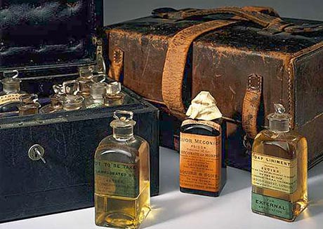 Photo of an old medicine chest with three bottles standing in front