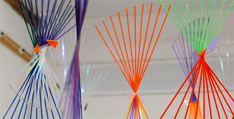 Photo of mobile comprising suspended coloured Perspex rods arranged in fan-shapes.