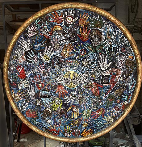 Large circular mosaic set withing a gold painted surround. 