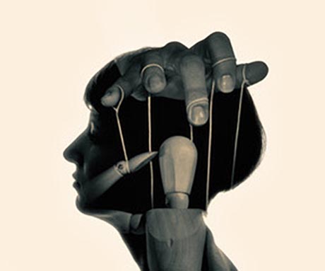 Image of fingers with strings attached controlling a marionette, all superimposed on the silhouette of a person's head